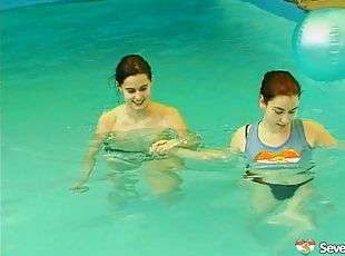 Salacious lesbians fondling in the pool before sharing a double ended dildo