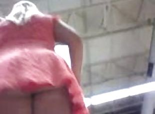 Chick wearing a miniskirt gets caught on a voyeur's cam