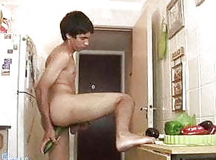 Lusty twink shoves a cucumber up the ass in the kitchen