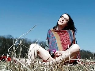 Hippie girl with glasses having fun outdoors