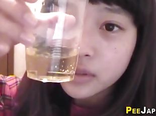 asian teen urinates in plastic glass