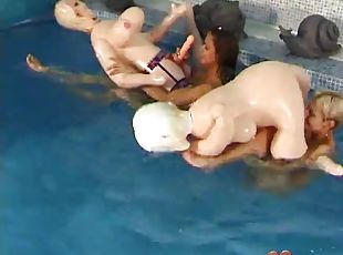 Two lesbian teens play with some blow up dolls in the pool