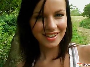 Brunette hottie inserts a vibrator in her pussy outdoors