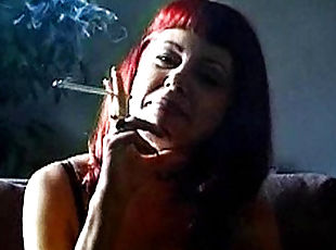 Mature redhead smokes and slowly strips