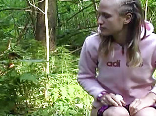 Braided hair girl pisses in the woods