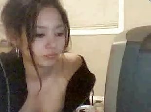 Sexy Asian teen in pajama shows her tits in webcam show