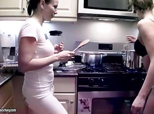 Two girls cooking naked in the kitchen