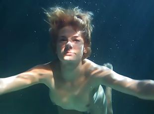 Curvaceous Russian takes down her clothes while under the water