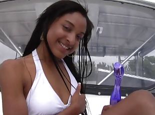 Smart ebony with tattoo and long hair in bikini drilling her pussy with toy in reality shoot