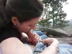Couple outdoors while the girl sucks him